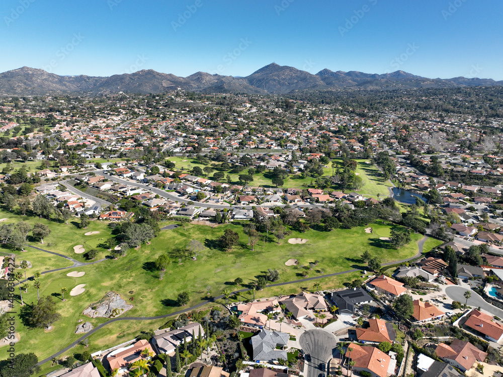Aerial view of green golf in upscale residential neighborhood in South California. USA. 