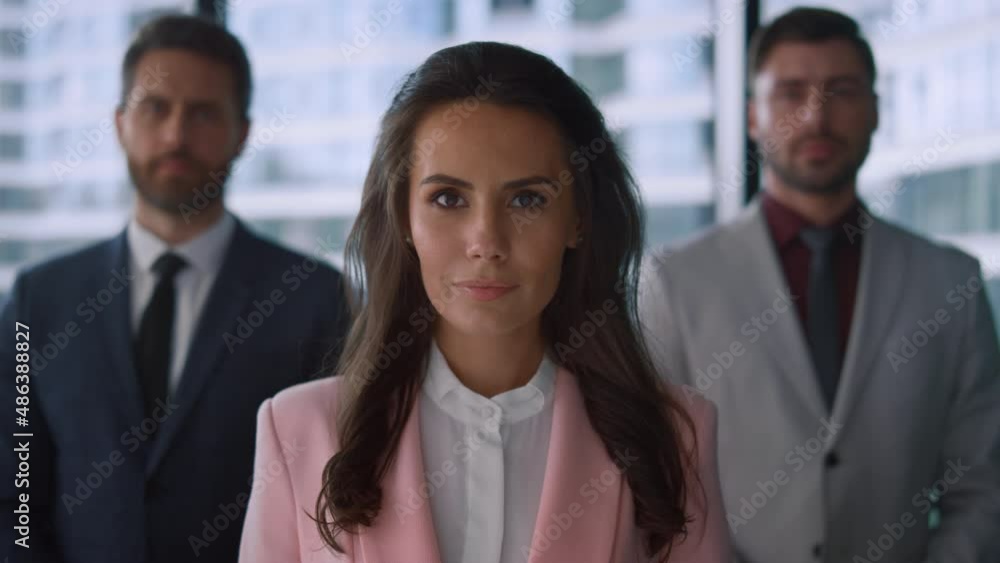 Ambitious business team posing looking camera in modern office. Teamwork concept