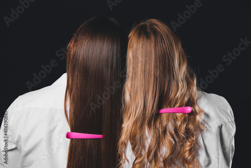 Women with beautiful long hair and hairpins on dark background