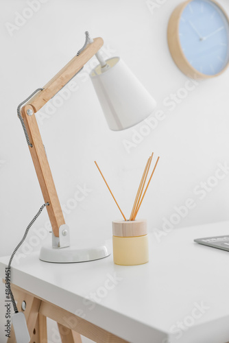 Aroma reed diffuser with lamp on table in room