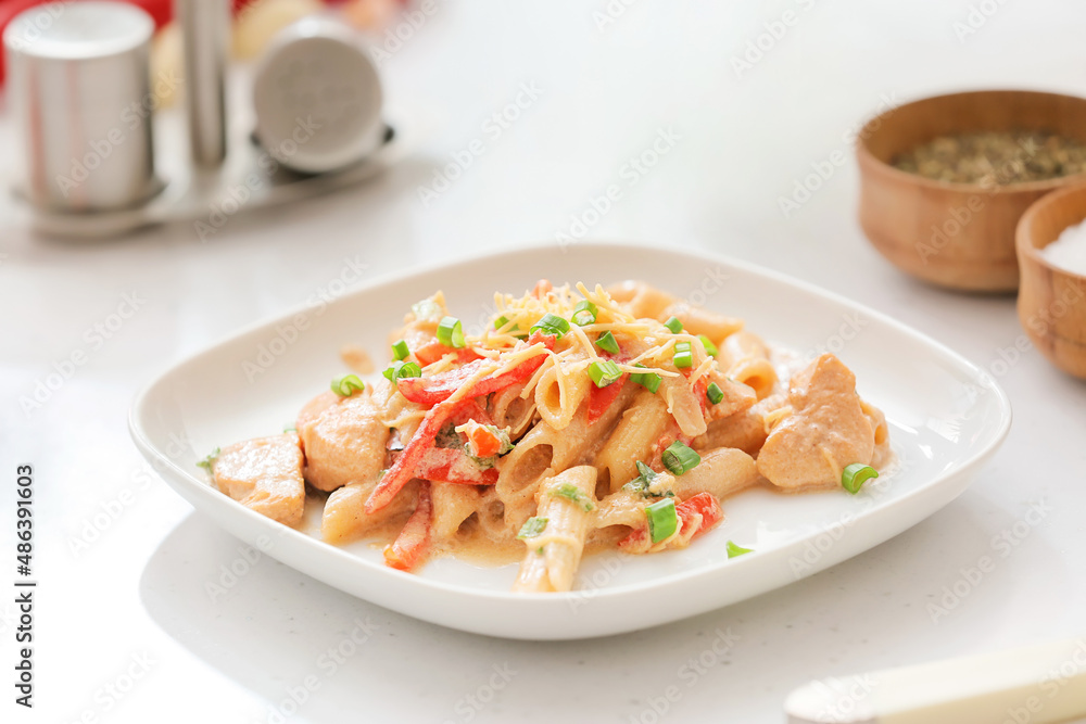 Plate with cajun chicken pasta on light table Plate with cajun chicken pasta on light table