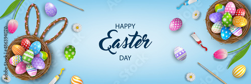 Happy easter banner with decorated eggs in the nest, brushes, tempera tubes and flowers