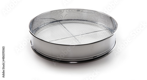 Screening. A chrome sieve or screen used for filtering wanted or unwanted elements..Also called mesh strainer or sift. Focus at center of screen net. isolated on white. photo