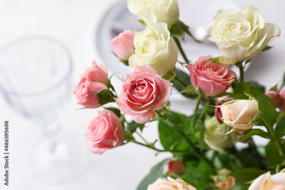 Bouquet of beautiful roses on served table, closeup Bouquet of beautiful roses on served table, closeup