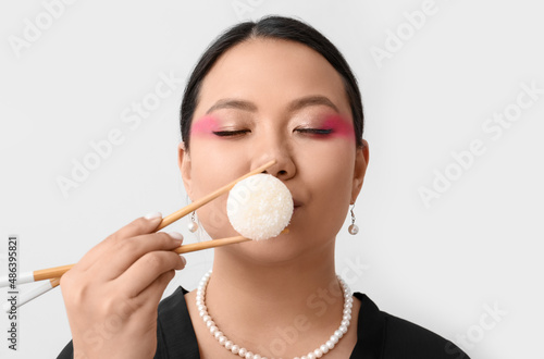 Beautiful Asian woman eatin...