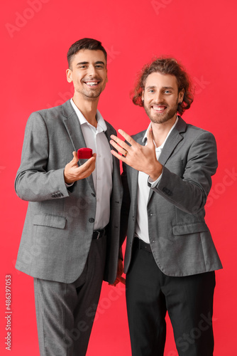 Happy engaged gay couple on...