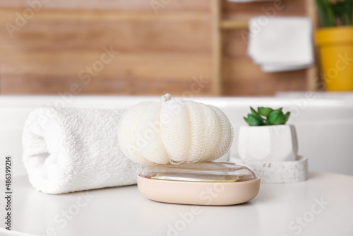 Set of bath accessories and houseplant on table, closeup
