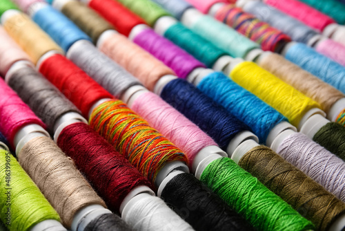 Spools with colorful sewing threads, closeup