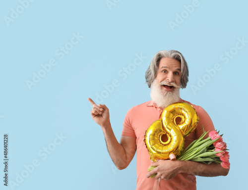 Senior man with tulips and ...