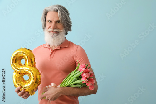 Senior man holding tulips a...