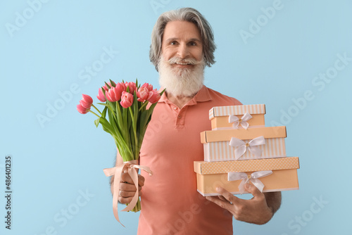 Senior man holding tulips a...