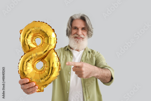 Senior man pointing at ball...