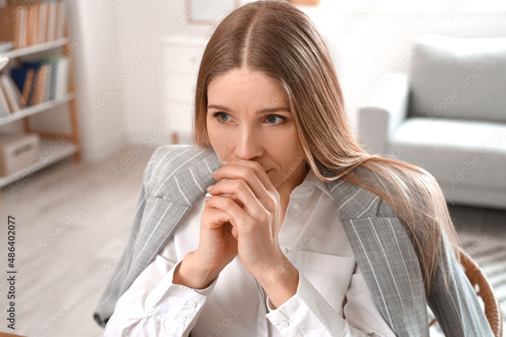 Worried businesswoman in office, closeup