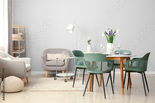 Interior of modern dining room with table served for International Women's Day celebration