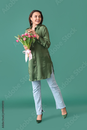 Smiling young woman holding...