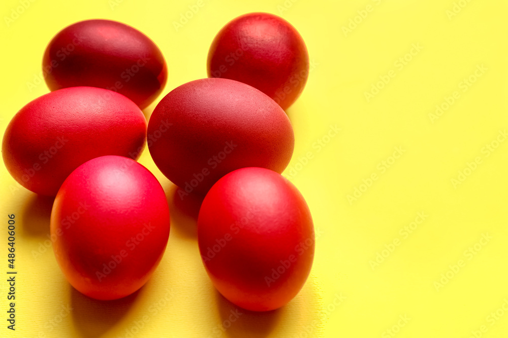 Red Easter eggs on yellow background, closeup Red Easter eggs on yellow background, closeup