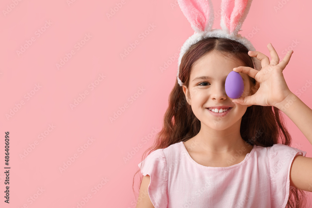 Cute little girl with bunny ears and Easter egg on pink background Cute little girl with bunny ears and Easter egg on pink background