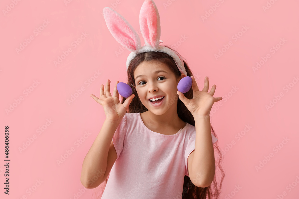 Cute little girl with bunny ears and Easter eggs on pink background Cute little girl with bunny ears and Easter eggs on pink background