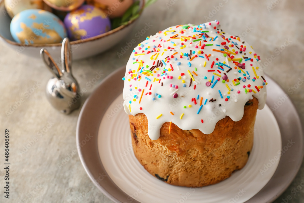 Plate with delicious Easter cake on grey background Plate with delicious Easter cake on grey background