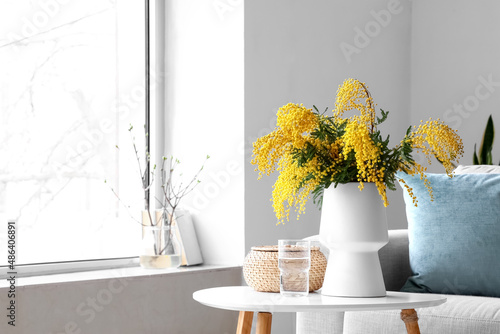Vase with mimosa flowers on...