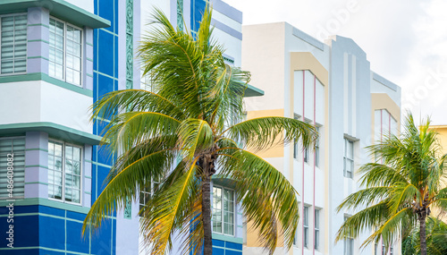 Closeup of typical colorful Art Deco architecture with tropical palm tree on Ocean Drive in South Beach, Miami, Florida, USA © SDF_QWE