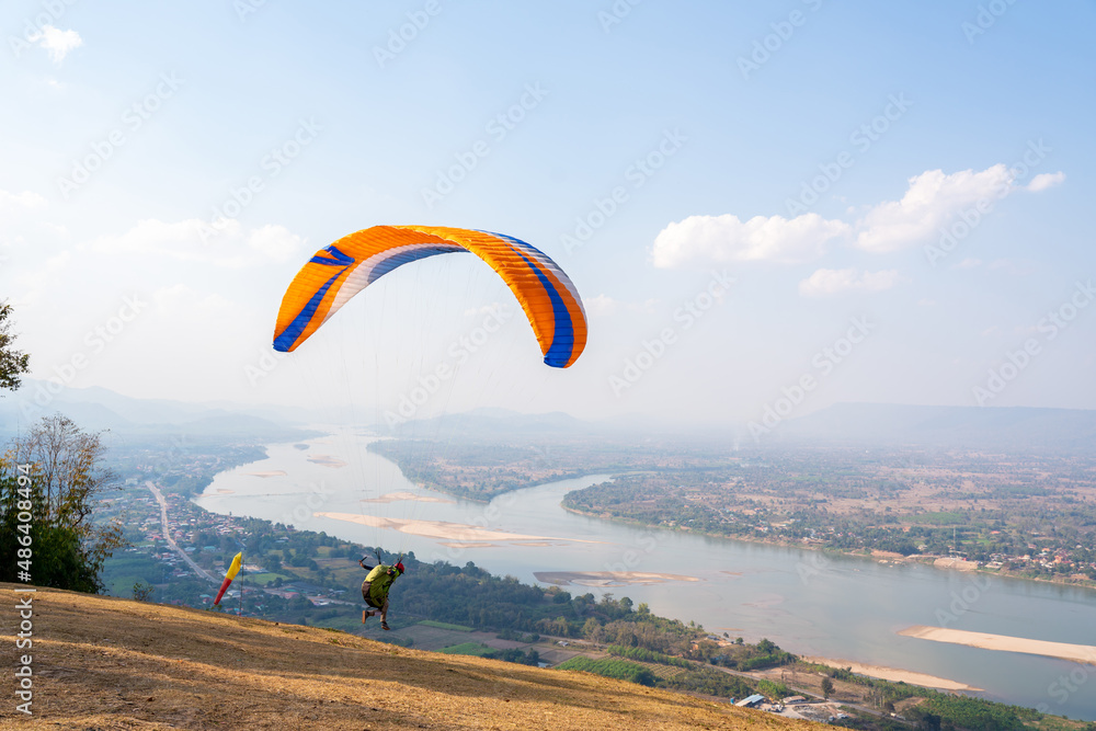 Paraglider flying on Mekong River at Pha Tak Suea, Nongkhai Thailand. Paraglider flying on Mekong River at Pha Tak Suea, Nongkhai Thailand.