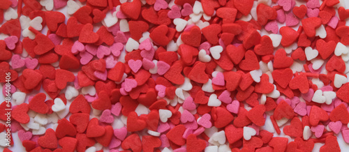 sprinkle hearts on a white background with a place for text