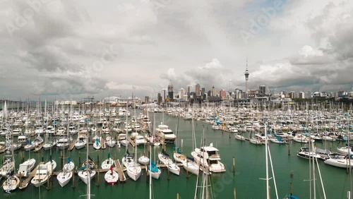 Westhaven Marina in Auckland city, morning view. Drone slowly flies over the yachts photo