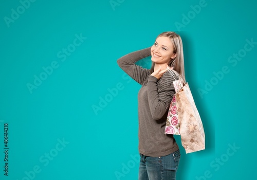 Happy smiling woman holding shopping bags, posing