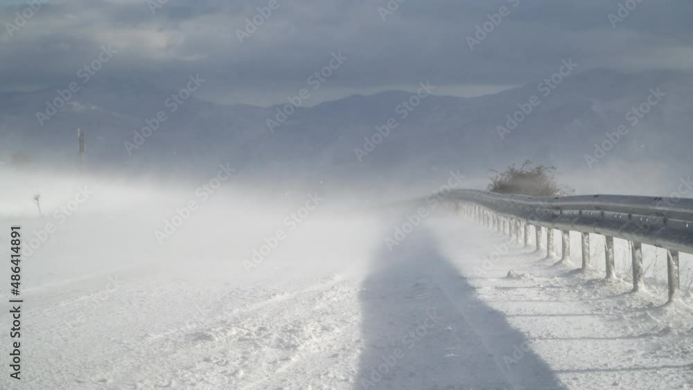 Winter mountain closed road with intense snowstorm snow blizzard drifting Winter mountain closed road with intense snowstorm snow blizzard drifting