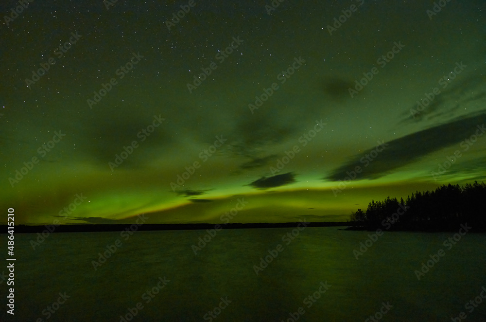 Northern lights over a lake in Suomussalmi Finland