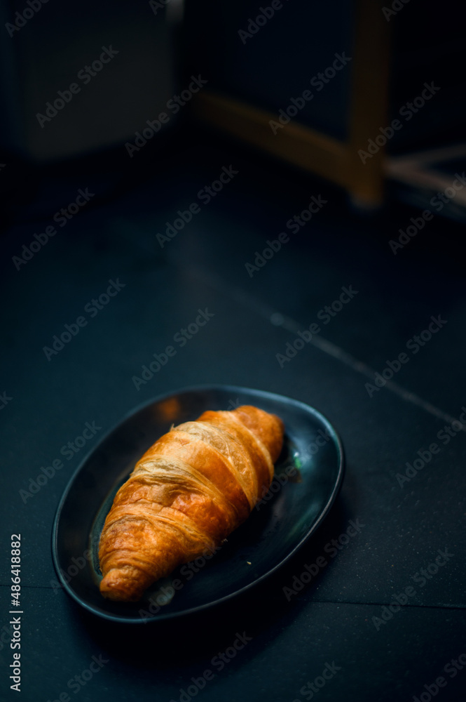 Breakfast with fresh croissants on black dish Breakfast with fresh croissants on black dish