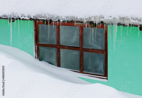 blizzard to the window of a house photo