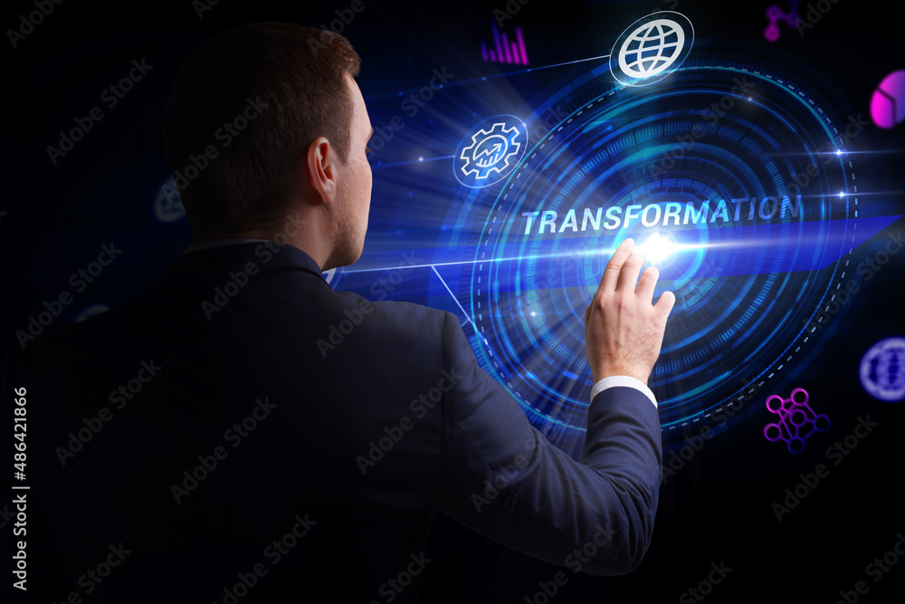 Business, Technology, Internet and network concept. Young businessman working on a virtual screen of the future and sees the inscription: Transformation Business, Technology, Internet and network concept. Young businessman working on a virtual screen of the future and sees the inscription: Transformation