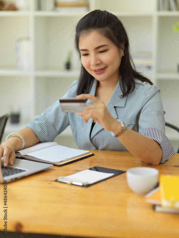 Portrait, Female paying her bills via online transaction Portrait, Female paying her bills via online transaction