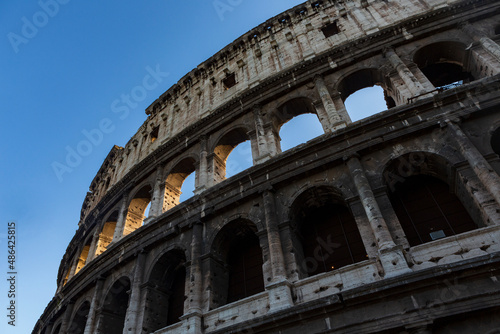 The sun sets on the Colosseum in Rome  Italy  the largest ancient amphitheatre ever built  during a cloudless summer day.