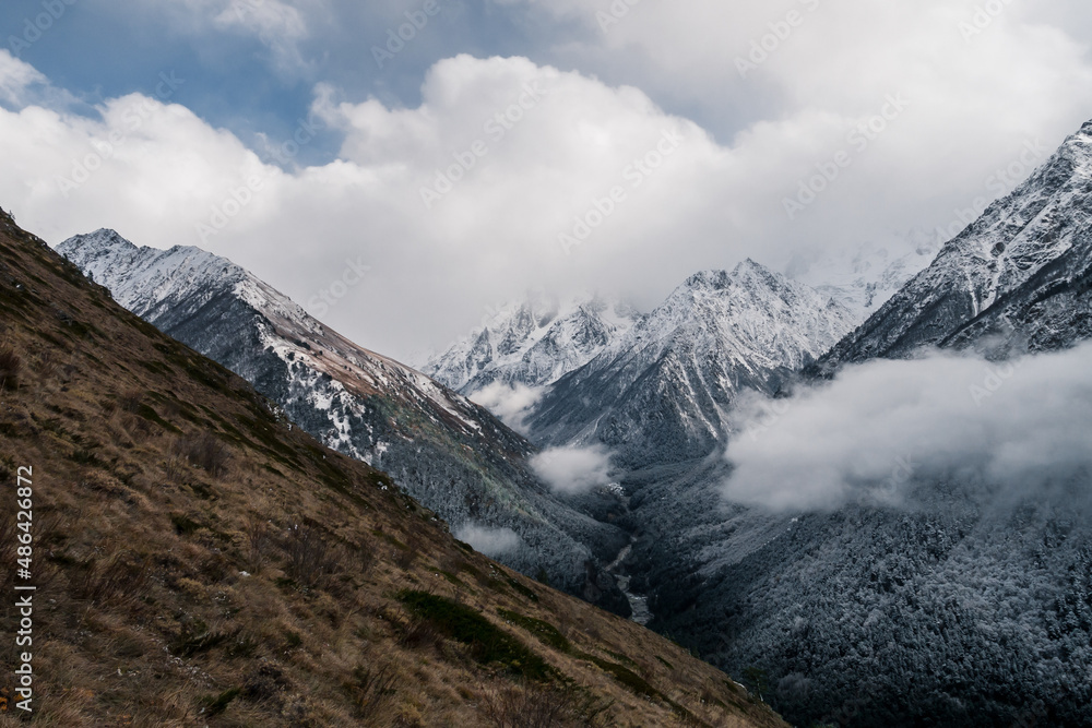 The Caucasus mountains in Russia. Beautiful landscape. Nature and cloudy mountain background.
