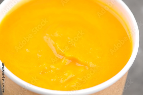 pumpkin cream soup in a cardboard glass
