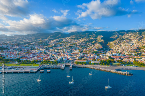 Aerial drone view of Funchal city center and port panorama in Madeira island in the evening. It's Portugal's Autonomous Region and is located in Atlantic ocean