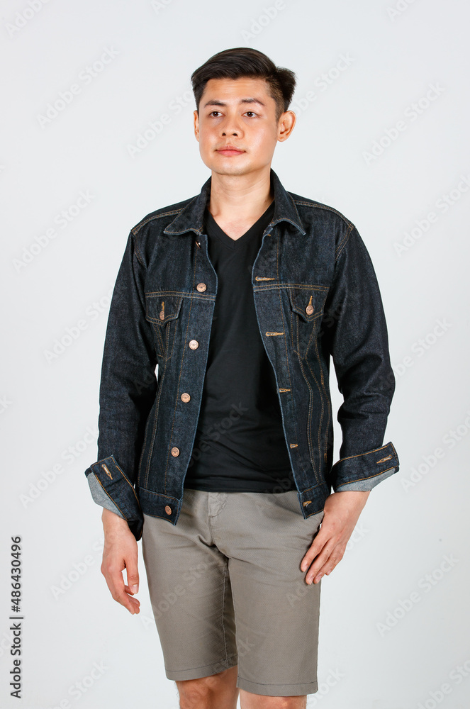 Portrait studio shot Asian young confident handsome cool short hair male hipster model wearing casual street wears denim jeans jacket standing crossed arms smiling look at camera on white background Portrait studio shot Asian young confident handsome cool short hair male hipster model wearing casual street wears denim jeans jacket standing crossed arms smiling look at camera on white background