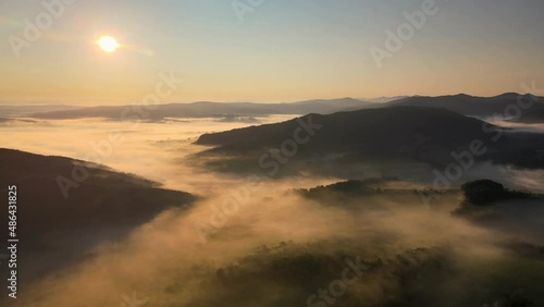 Wallpaper Mural Aerial high altitude shot over the foggy mountains on sunrise Torontodigital.ca