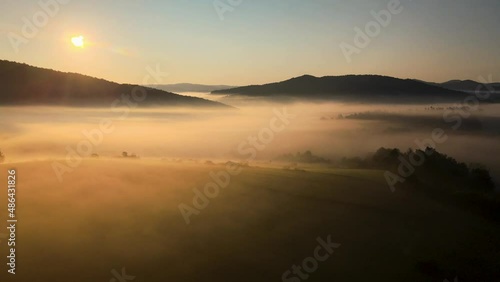 Wallpaper Mural Aerial shot against the sun over the misty meadows in mountains Torontodigital.ca