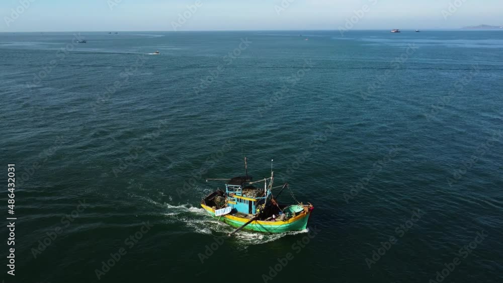 Aerial tracking shot of fisherman boat returning home after fishing day Aerial tracking shot of fisherman boat returning home after fishing day