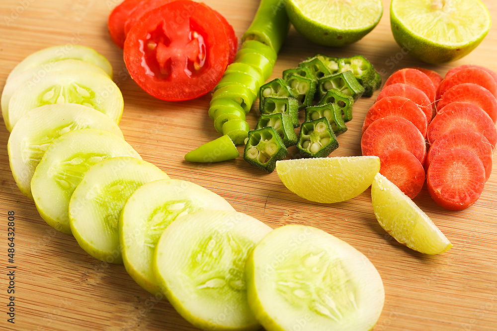 Helthy food concept : Raw vegetable slices on wooden board Helthy food concept : Raw vegetable slices on wooden board