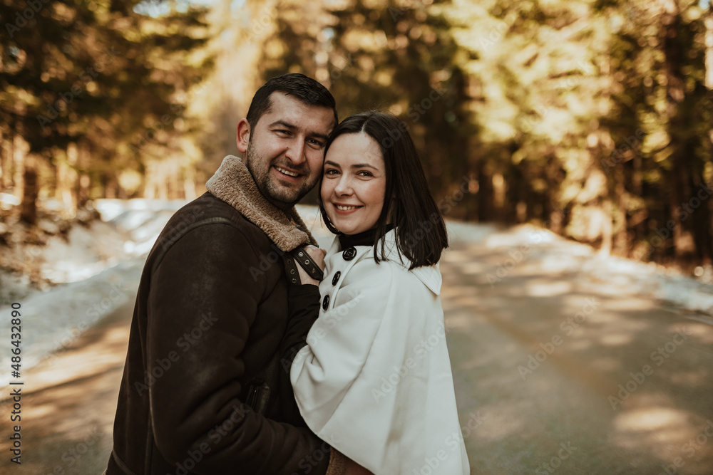 Portrait of handsome man hugging his loving wife on a winter day. Selective focus. Portrait of handsome man hugging his loving wife on a winter day. Selective focus.