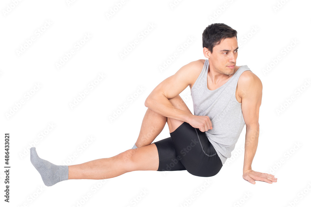 Determined sportsman stretching buttocks muscles in studio