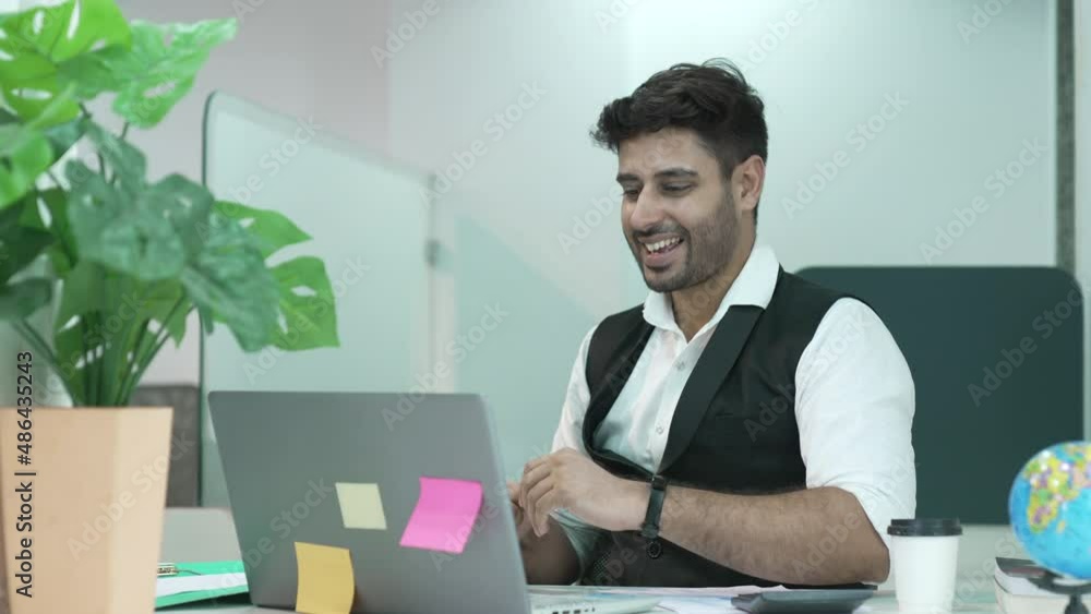 Young Indian businessman in formal wear looking at laptop screen, excited by unbelievable good news. Happy emotional executive celebrating receiving attracted investment notification. Young Indian businessman in formal wear looking at laptop screen, excited by unbelievable good news. Happy emotional executive celebrating receiving attracted investment notification.