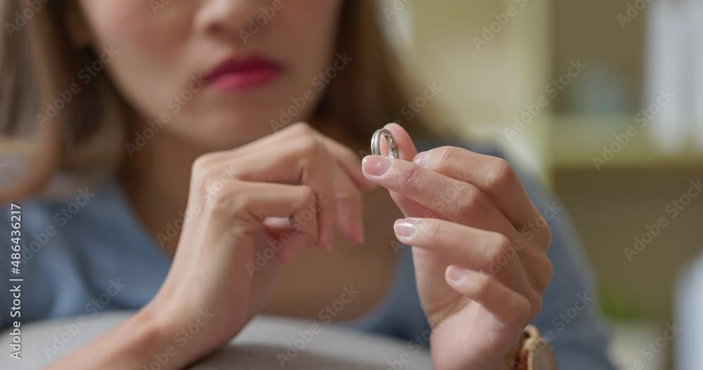 woman taking off wedding ring woman taking off wedding ring