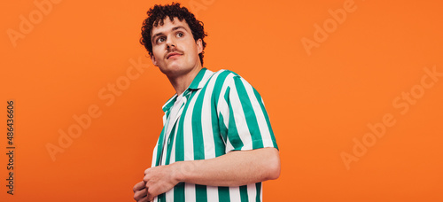 Obraz na płótnie Queer man looking away in a studio