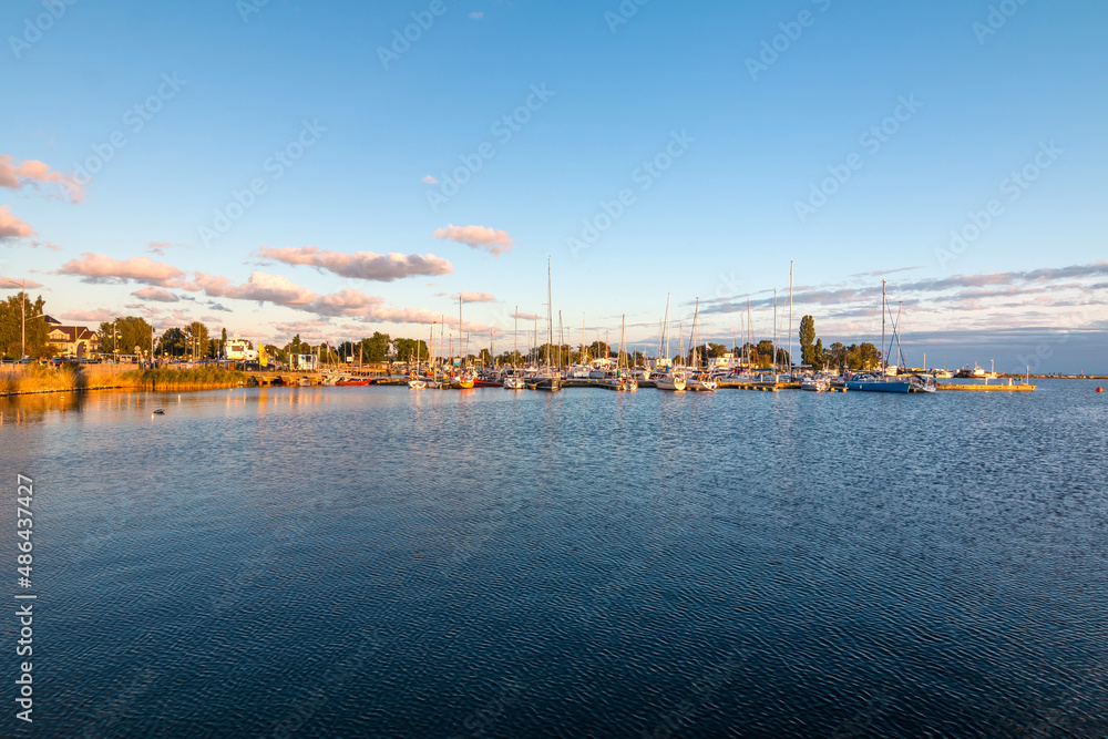 Harbor of the tiny holiday resort town Jastarnia in the North Coast of Poland, Baltic Sea. Sunset time